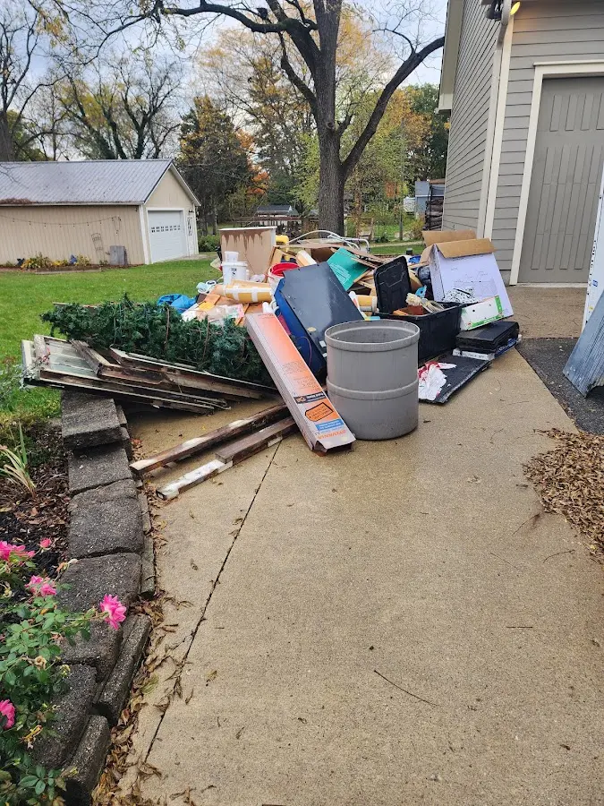 Dumpster being loaded with debris for Roofing Dumpster Rental in Boonville